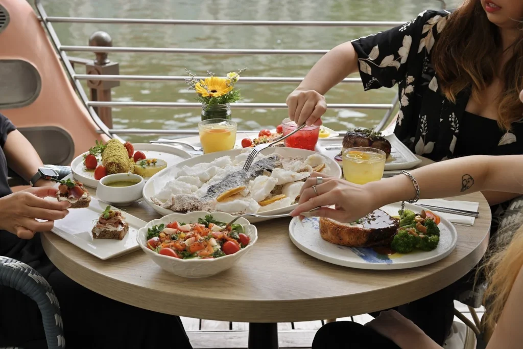 Festive communal feast shared at a riverside table at Zorba The Greek Taverna Clarke Quay Singapore