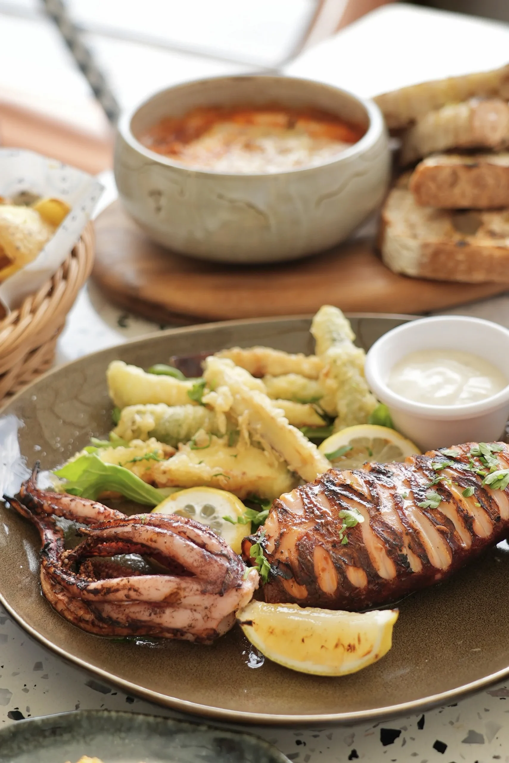 Grilled squid with fries, dip and bread for delivery and takeaway from Zorba The Greek Taverna Singapore