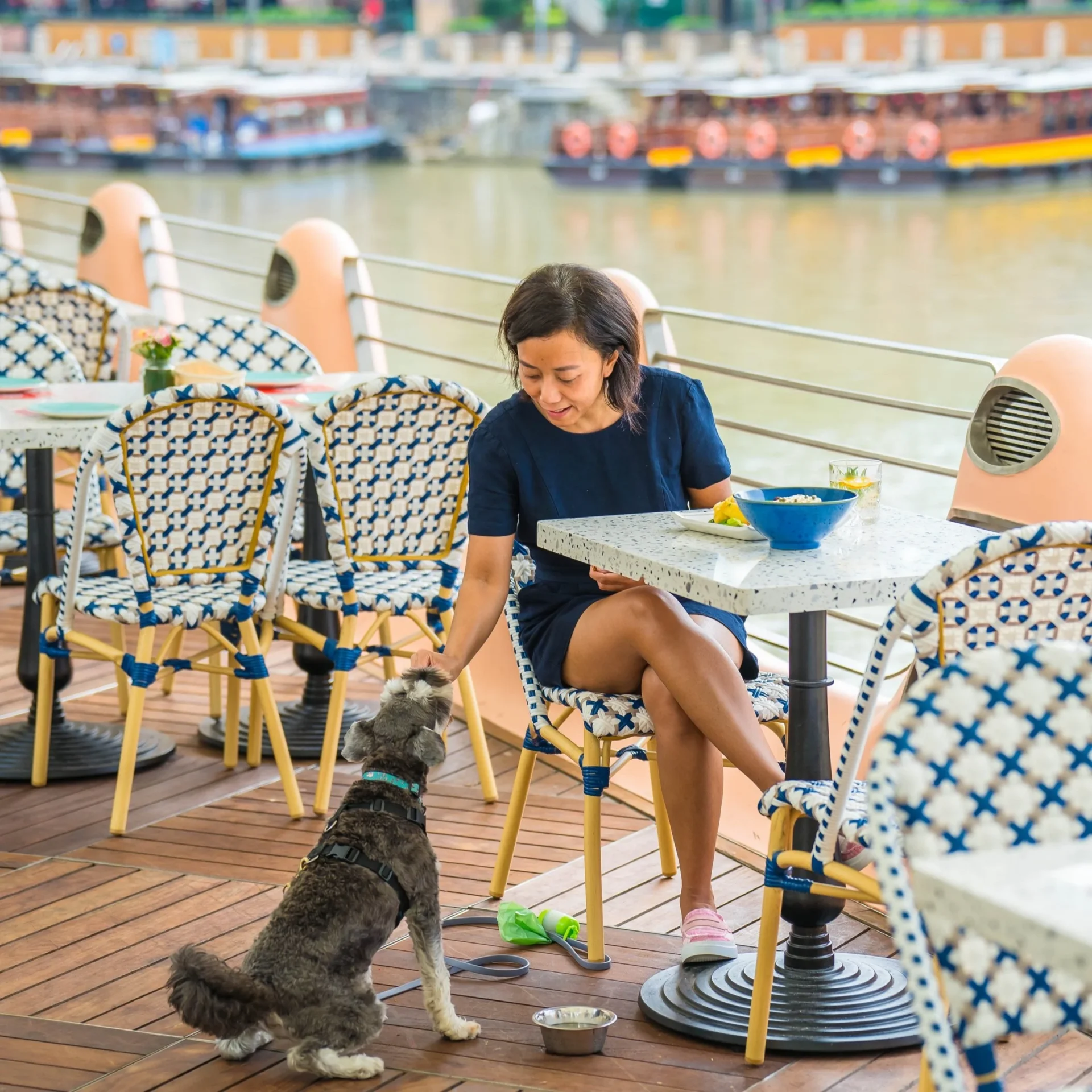Diner with her dog at a pet-friendly riverside table at Zorba The Greek Taverna Clarke Quay Singapore